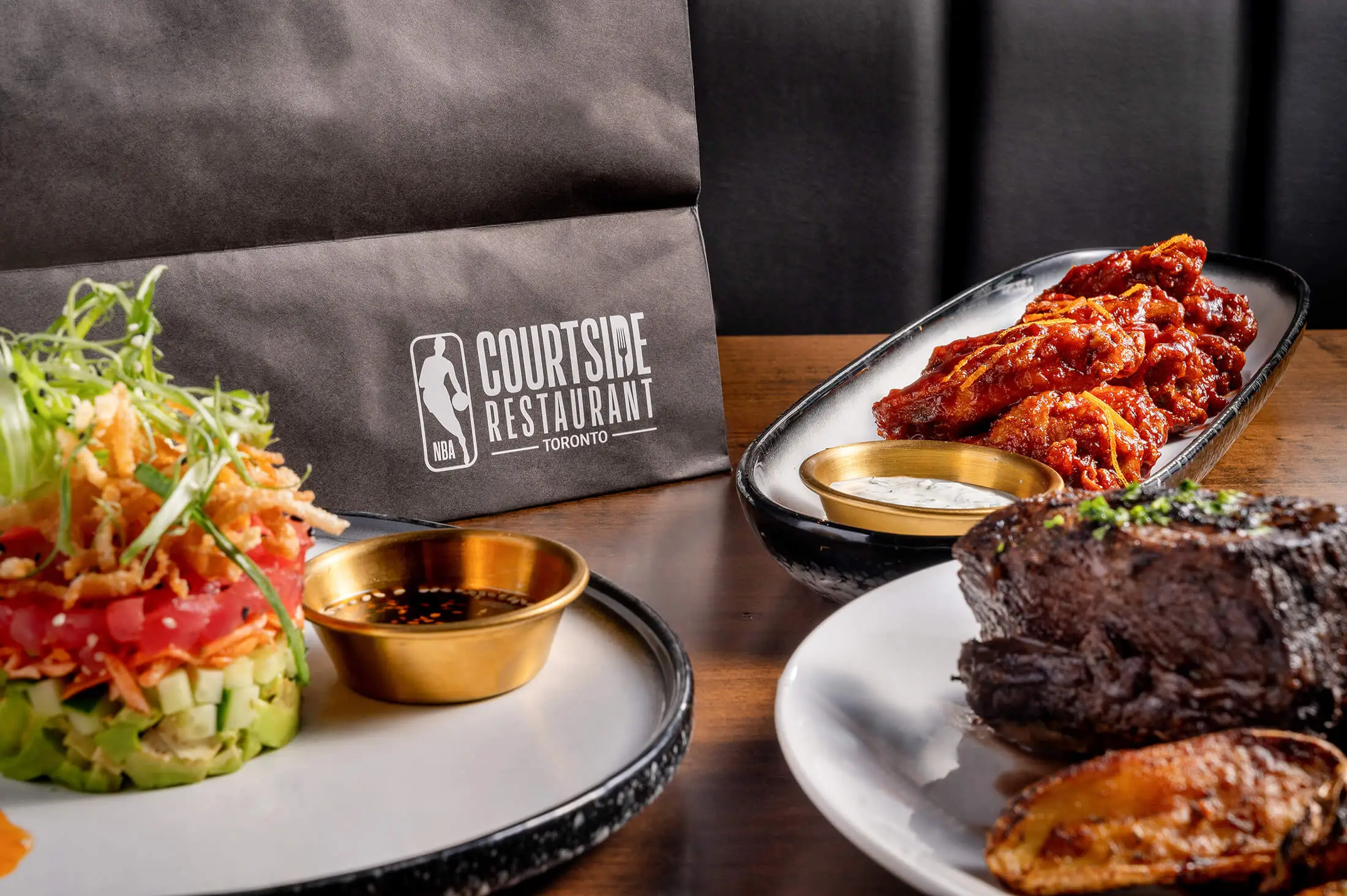 NBA Courtside Restaurant Menu Close up shot of Steak Wings and Salad